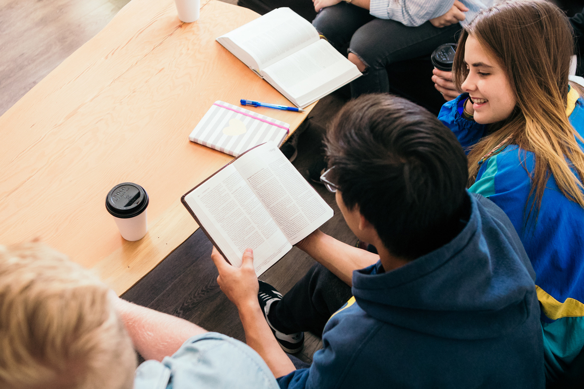 Small group gathered around Bibles and conversation